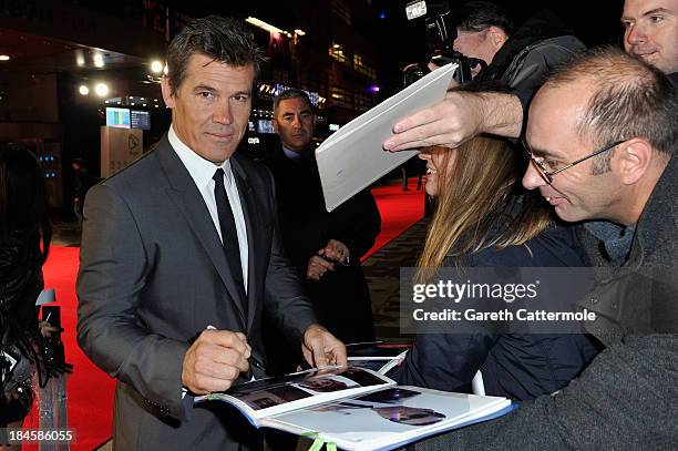 Actor Josh Brolin signs autographs as he arrives to the Mayfair Gala European Premiere of "Labor Day" during the 57th BFI London Film Festival at...