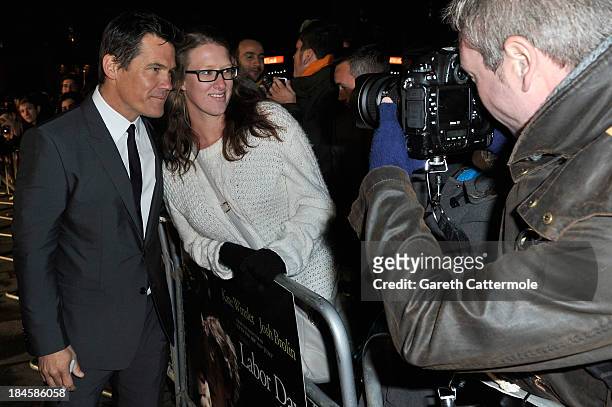 Actor Josh Brolin poses with fan as he arrives to the Mayfair Gala European Premiere of "Labor Day" during the 57th BFI London Film Festival at Odeon...