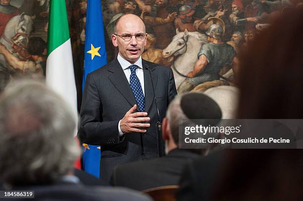 Italian Prime Minister Enrico Letta gestures as he attends a meeting with the Jewish Community to commemorate the 70th anniversary of the deportation...