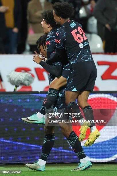 Manchester City's English midfielder Micah Hamilton celebrates scoring his team's second goal with teammates during the UEFA Champions League Group G...