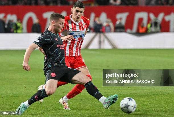 Manchester City's Spanish defender Sergio Gomez fights for the ball with Red Star's Serbian defender Kosta Nedeljkovic during the UEFA Champions...