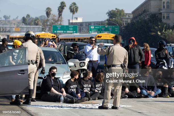 Demonstrators block the 110 freeway in downtown on Wednesday, Dec. 13, 2023 in Los Angeles, CA to call for a ceasefire in the Israeli-Hamas conflict.