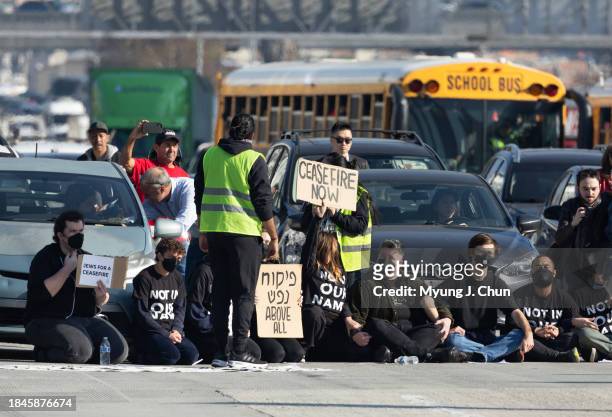 Demonstrators block the 110 freeway in downtown on Wednesday, Dec. 13, 2023 in Los Angeles, CA to call for a ceasefire in the Israeli-Hamas conflict.