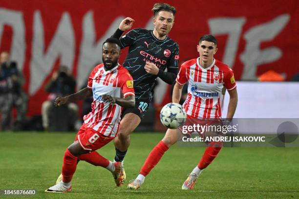 Red Star's Gabonese midfielder Guelor Kanga Kakou fights for the ball with Manchester City's English midfielder Jack Grealish and Red Star's Serbian...