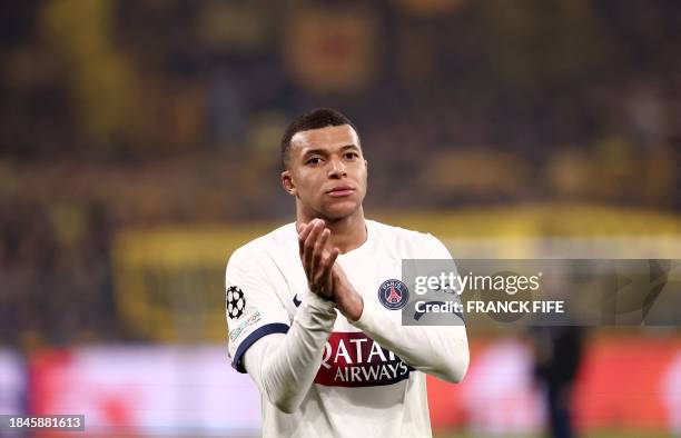 Paris Saint-Germain's French forward Kylian Mbappe reacts after the UEFA Champions League group F football match between BVB Borussia Dortmund and...