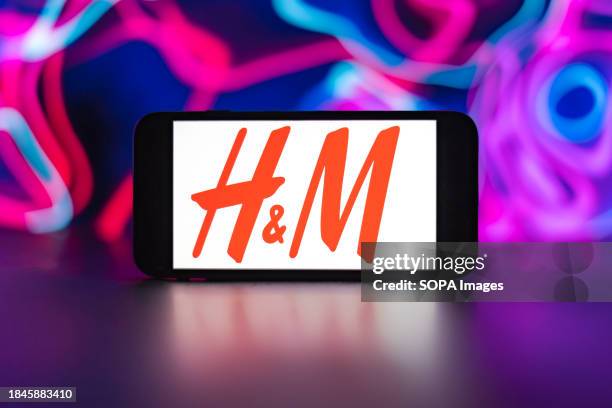 In this photo illustration, the H&M logo is seen displayed on a mobile phone screen.