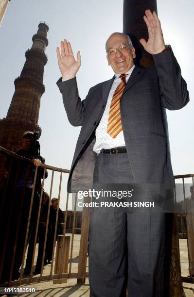 Swiss President Pascal Couchepin raises his hands after a failed attempt to join his hands around an Iron pillar during his visit to the famed Qutab...