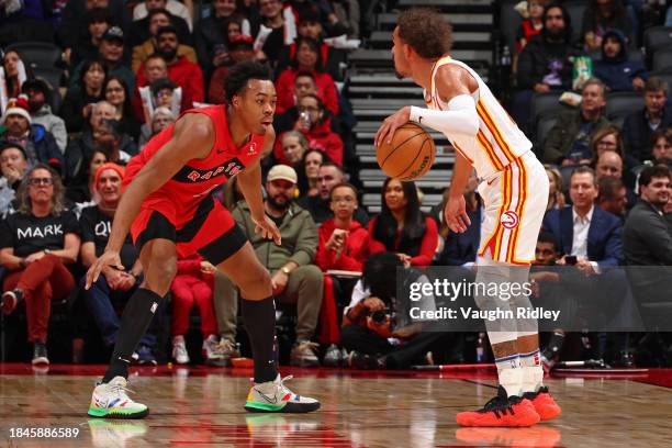 Scottie Barnes of the Toronto Raptors plays defense during the game against the Atlanta Hawks on December 13, 2023 at the Scotiabank Arena in...
