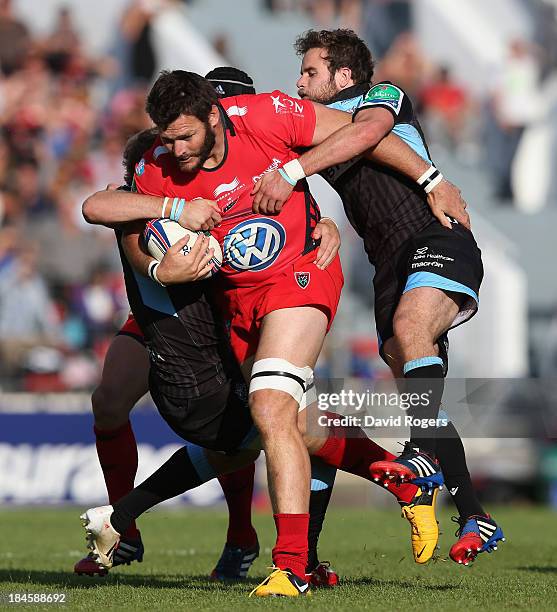 Daniel Rossouw of Toulon is tackled by Ruaridh Jackson and Byron McGuigan during the Heineken Cup Pool 2 match between Toulon and Glasgow Warriors at...