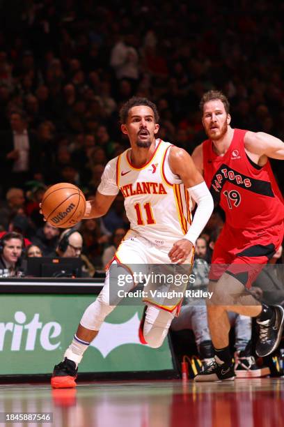 Trae Young of the Atlanta Hawks handles the ball during the game against the Toronto Raptors on December 13, 2023 at the Scotiabank Arena in Toronto,...