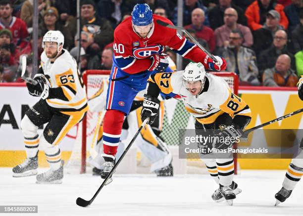 Joel Armia of the Montreal Canadien jumps over Sidney Crosby of the Pittsburgh Penguins during the third period at the Bell Centre on December 13,...