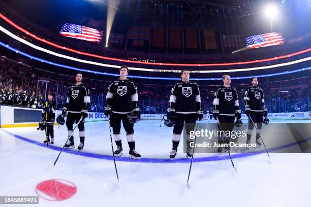 Los Angeles Kings look on during the National Anthem with Make-A-Wish recipient Jacob Brown prior to the first period against the Winnipeg Jets at...