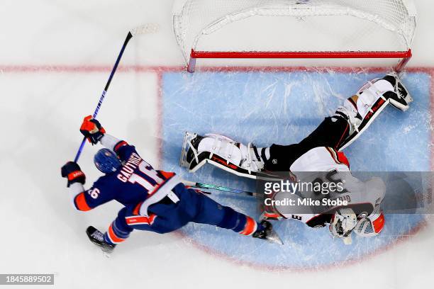 John Gibson of the Anaheim Ducks makes a save against Julien Gauthier of the New York Islanders during the second period at UBS Arena on December 13,...