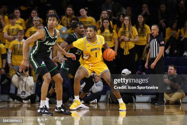 Toledo Rockets forward Javan Simmons looks to make a move to the basket while being defended by Marshall Thundering Herd forward Obinna...