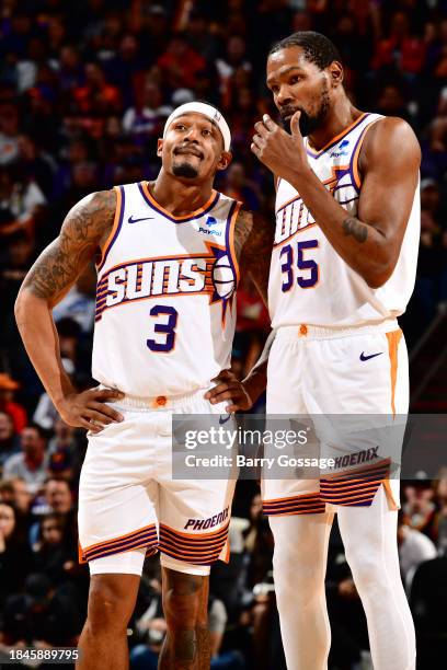 Bradley Beal and Kevin Durant of the Phoenix Suns look on during the game against the Brooklyn Nets on December 13, 2023 at Footprint Center in...