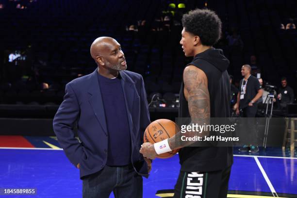 Gary Payton and MarJon Beauchamp of the Milwaukee Bucks talk before the game against the Indiana Pacers during the semifinals of the In-Season...