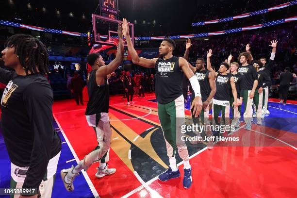 Giannis Antetokounmpo and Malik Beasley of the Milwaukee Bucks high five before the game against the Indiana Pacers during the semifinals of the...
