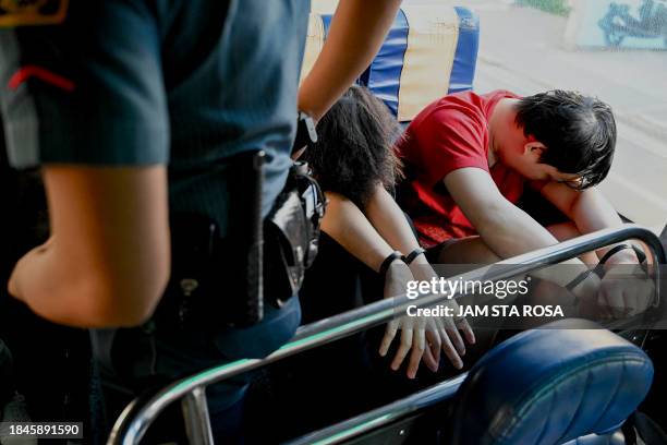 Chinese nationals are seen on a bus ahead of their deportation after they were detained in a raid on a suspected sex trafficking and online scam...