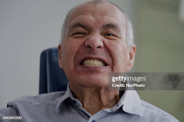 An older adult is smiling after having a dental prosthesis fitted at the Centro de Salud TIII Doctor Guillermo Roman y Carrillo Dental Clinic in the...