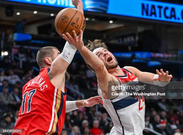 Washington Wizards forward Corey Kispert is fouled by New Orleans Pelicans center Jonas Valanciunas during second half action at Capital One Arena on...