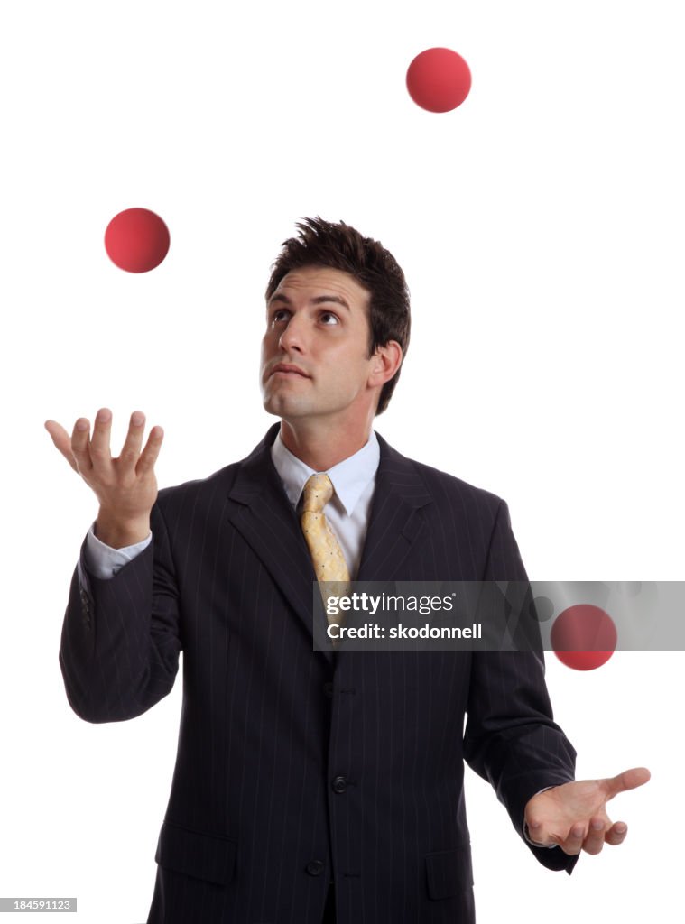 Businessman Juggling Red Balls