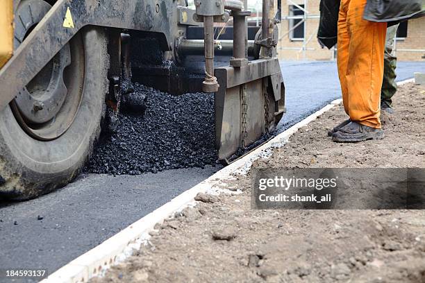 laying a new road - asphalt paver stock pictures, royalty-free photos & images