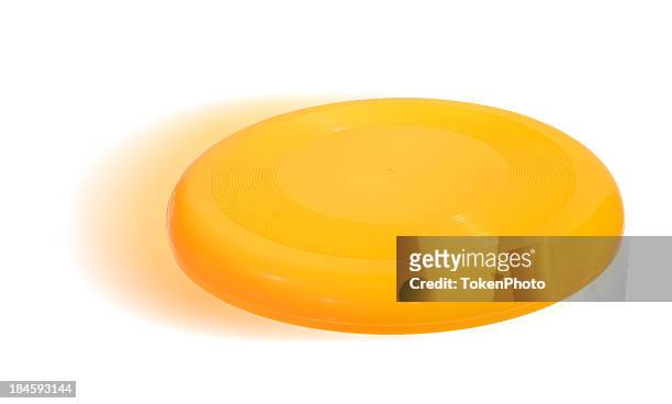 isolated image of a yellow frisbee - frisbee stock pictures, royalty-free photos & images