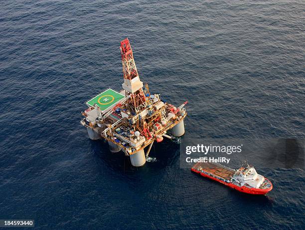 oil rig and support ship - water craft stock pictures, royalty-free photos & images