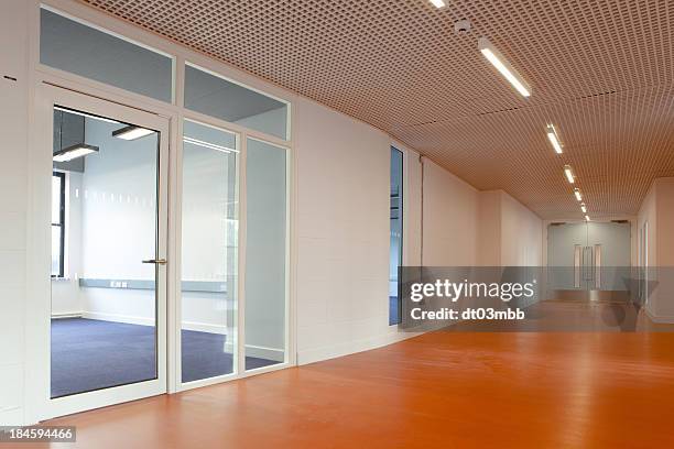 empty office space featuring a laminate wood floor corridor - glass door stock pictures, royalty-free photos & images