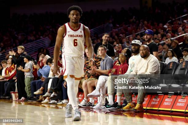 LeBron James looks on from the stands towards Bronny James of the USC Trojans during the first half against the Long Beach State 49ers at Galen...