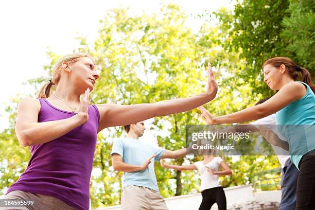 group of young people practicing tai chi outdoor - kung fu stock pictures, royalty-free photos & images