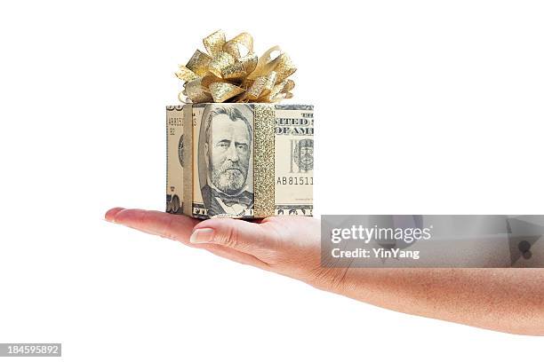 hand offering gift of money in gold ribbon on white - wrapping arm stock pictures, royalty-free photos & images