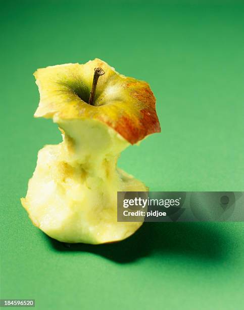 apple core with missing bites - missing bite stock pictures, royalty-free photos & images