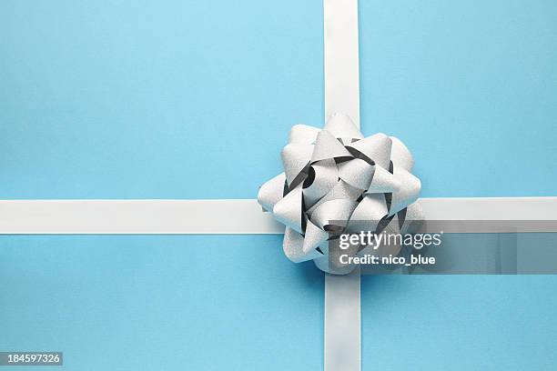 silver bow on blue - wrapped stock pictures, royalty-free photos & images