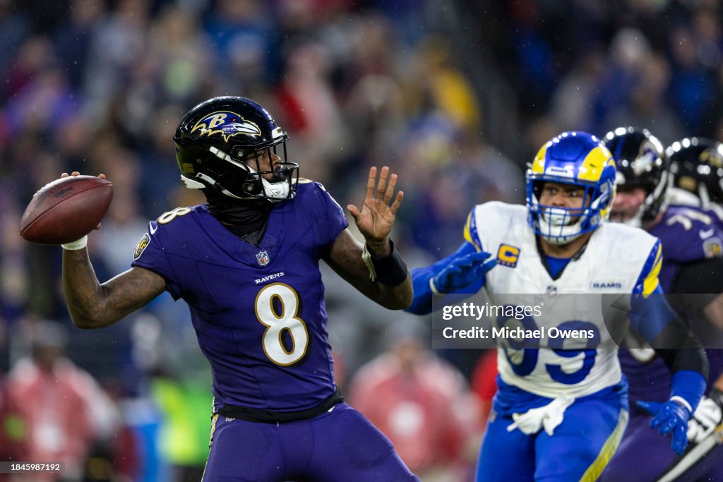 Lamar Jackson of the Baltimore Ravens throws a pass as Aaron Donald ...