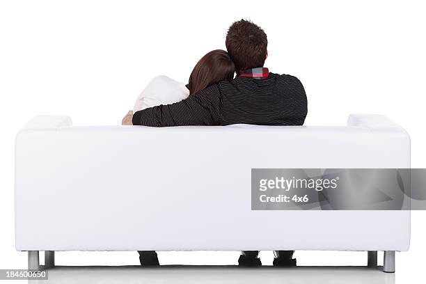 rear view of a couple sitting together - back of sofa stock pictures, royalty-free photos & images