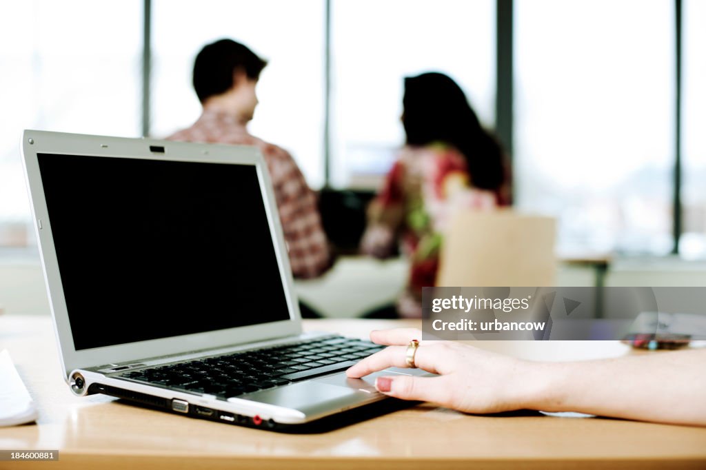 Female hand on laptop