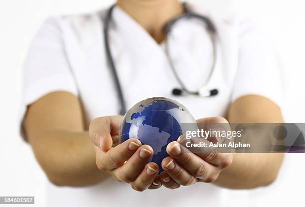 global healthcare - holding globe stock pictures, royalty-free photos & images