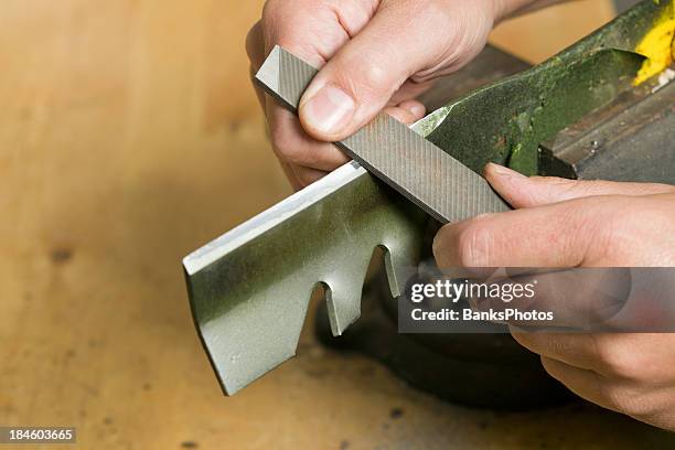 lawnmower blade sharpening with file - grasmaaier stockfoto's en -beelden