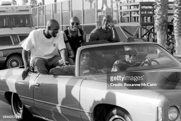 Scottie Pippen of the Chicago Bulls rides in the passenger seat of a convertible, with Reggie Miller of the Indiana Pacers driving and Tim Hardaway...