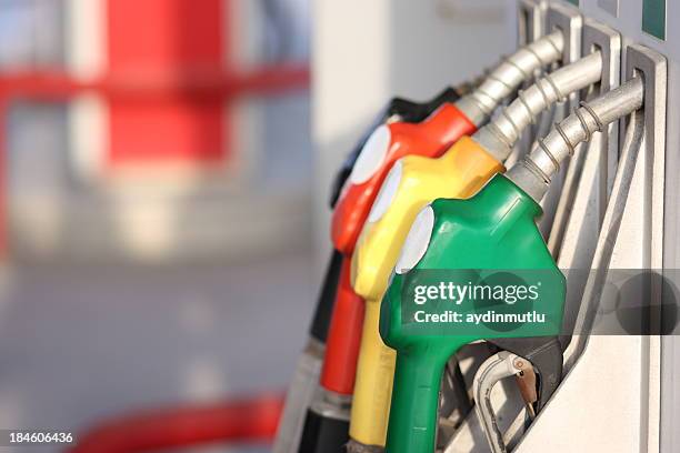 different types of fuel pumps identified with colors - gas pump stockfoto's en -beelden