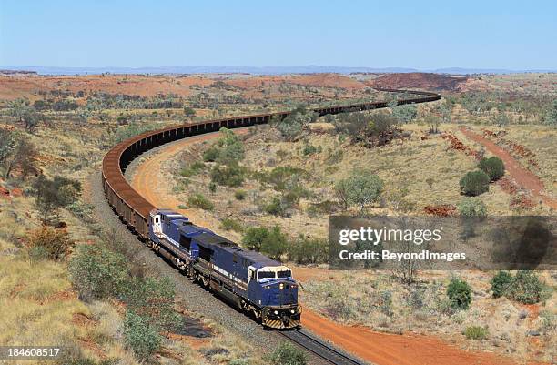 huge trainload of 'red gold' heads to port - mine train stock pictures, royalty-free photos & images