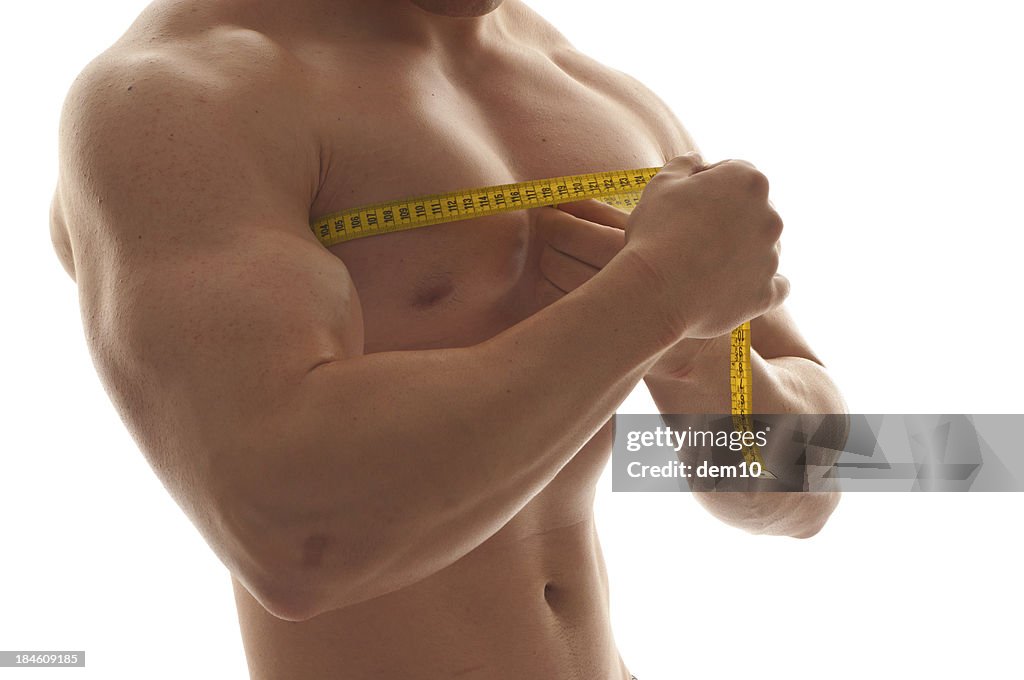 Man measuring his chest with a tape measure