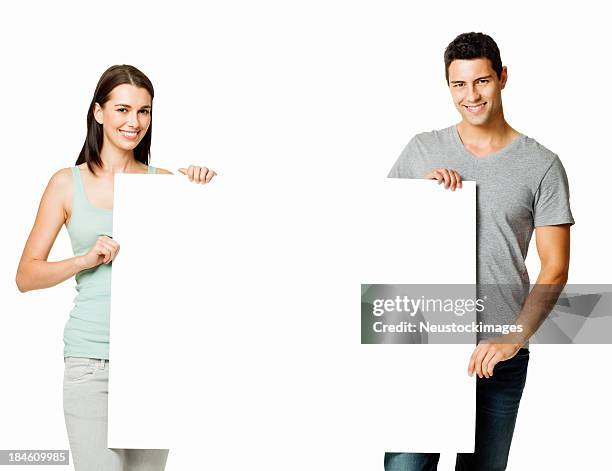 young couple holding a blank sign - isolated - man holding placard stock pictures, royalty-free photos & images