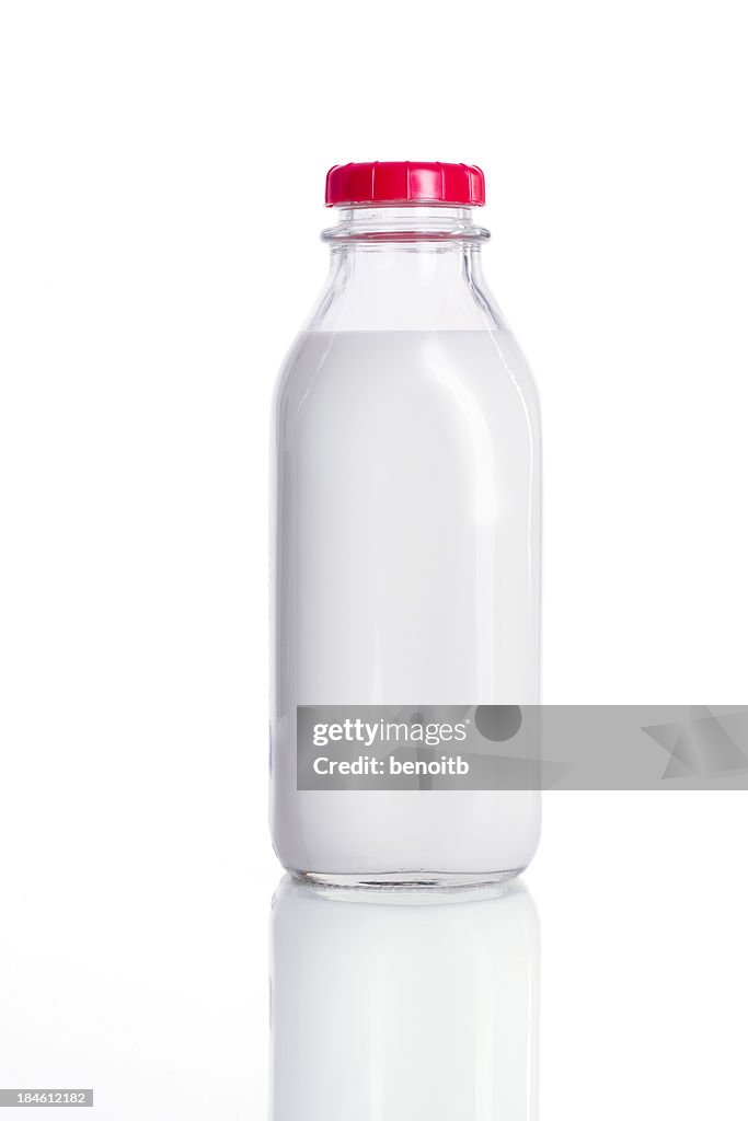 Fresh glass bottle of milk with a red lid