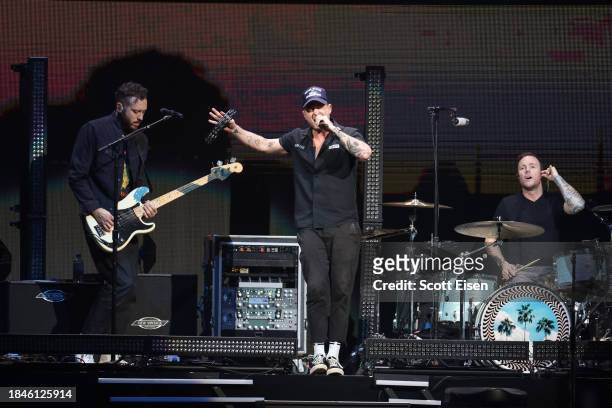 Brent Kutzle, Ryan Tedder, and Eddie Fisher of One Republic perform onstage during iHeartRadio KISS108's Jingle Ball 2023 at TD Garden on December...