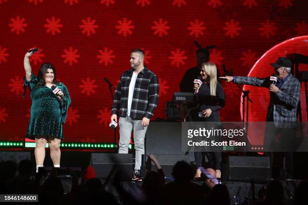 Winnie, Justin, Lisa Donovan, and Billy Costa speak onstage during iHeartRadio KISS108's Jingle Ball 2023 at TD Garden on December 10, 2023 in...