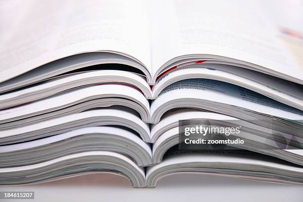 a bunch of open magazines stacked on top one another - article stock pictures, royalty-free photos & images