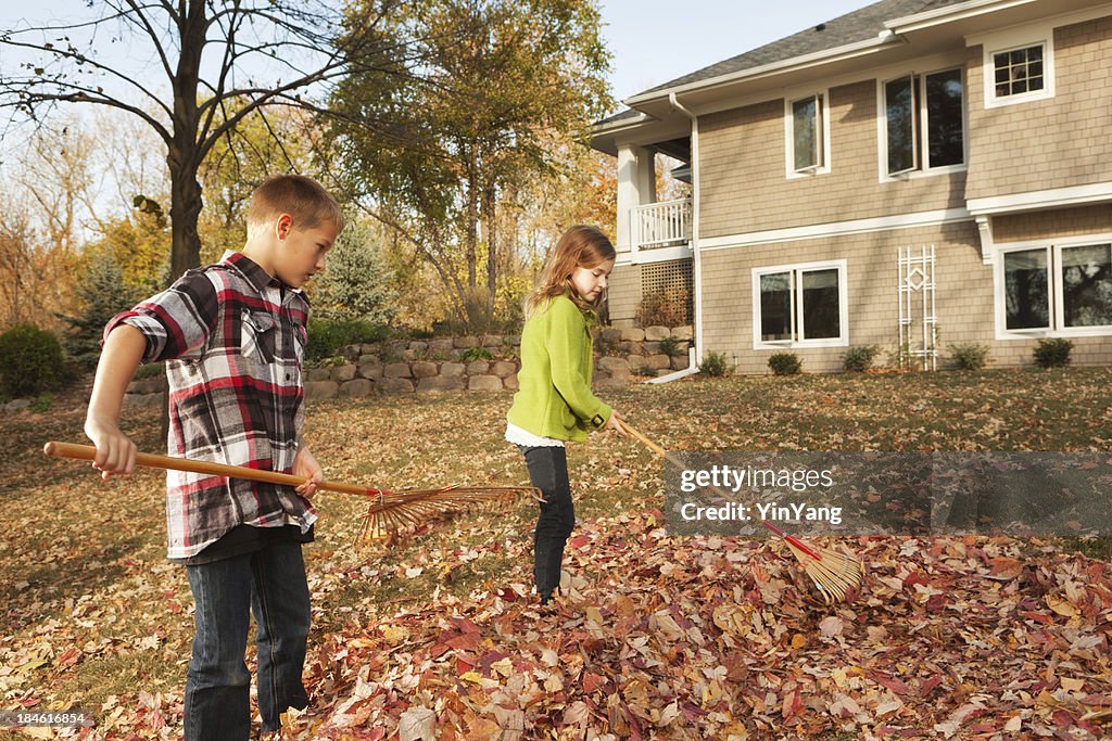 Family Working Together Raking Fall Leaves at Backyard of Home