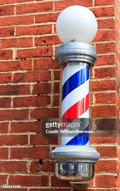 old fashioned barbershop pole on brick wall - barber pole stock pictures, royalty-free photos & images